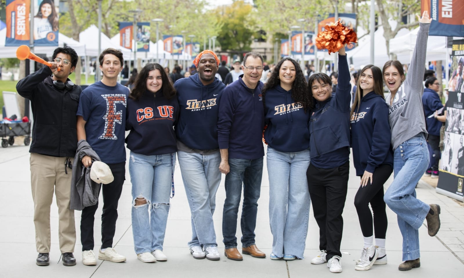 A group of students gather at an event on a college campus.